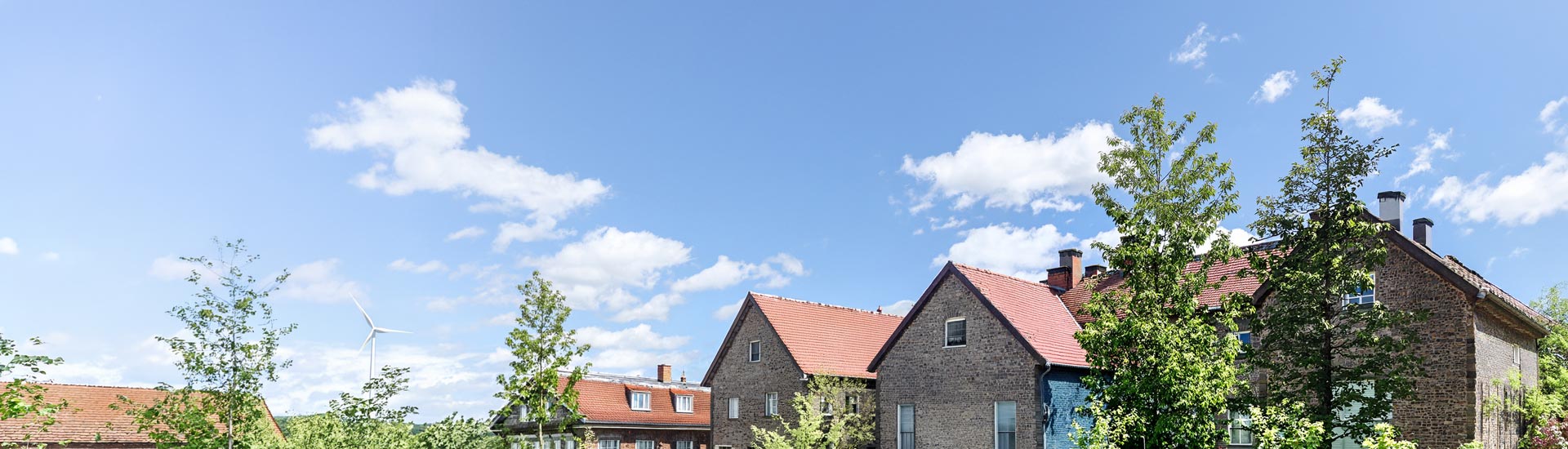 Alte Häuser und Windrad im Hintergrund,